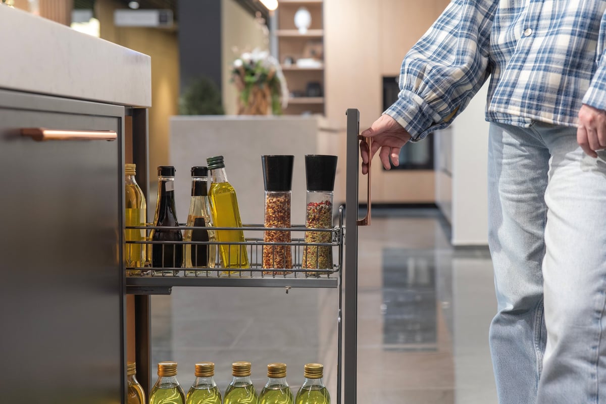 Woman organizing kitchen drawer with joy